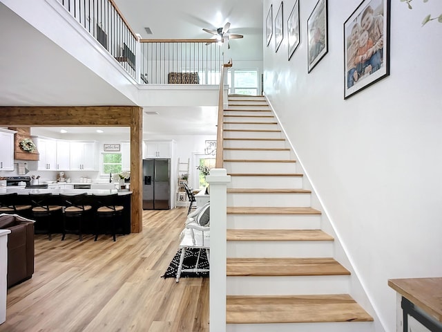 8975 Reid Packing House Rd, Hastings, FL 32145 - staircase with wood finished floors, a towering ceiling, and a ceiling fan