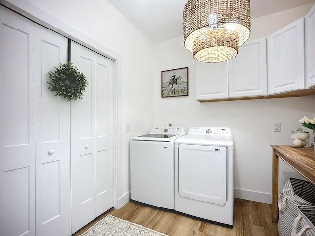 8975 Reid Packing House Rd, Hastings, FL 32145 - laundry room featuring separate washer and dryer, cabinet space, light wood-type flooring, and a chandelier