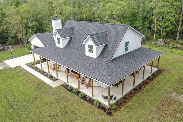 8975 Reid Packing House Rd, Hastings, FL 32145 - view of front of property with a chimney, a front yard, a view of trees, a patio, and roof with shingles