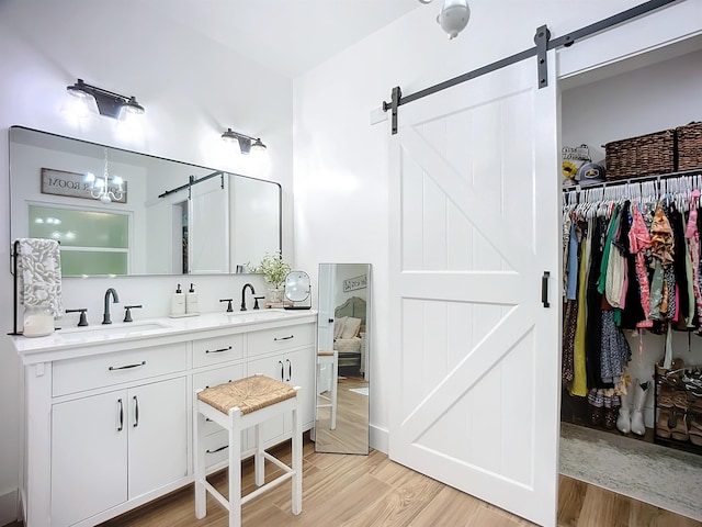 8975 Reid Packing House Rd, Hastings, FL 32145 - full bathroom with double vanity, wood finished floors, and a spacious closet
