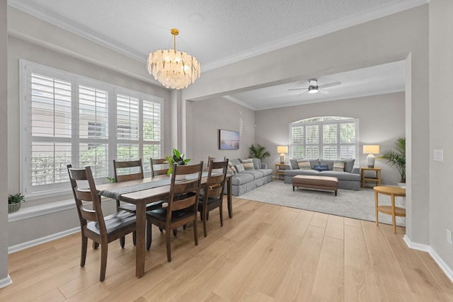 dining space featuring ornamental molding, plenty of natural light, and light hardwood / wood-style floors