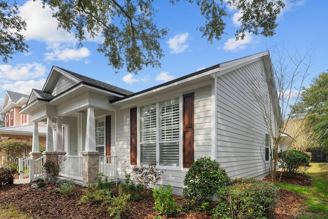 view of property exterior featuring covered porch