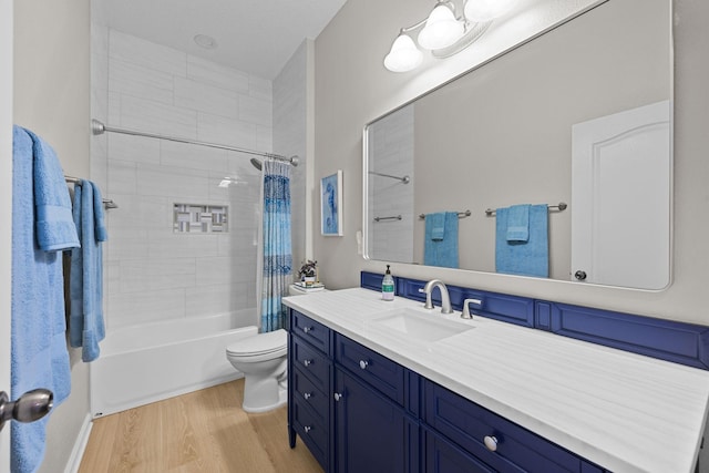 full bathroom featuring shower / tub combo, vanity, hardwood / wood-style flooring, and toilet