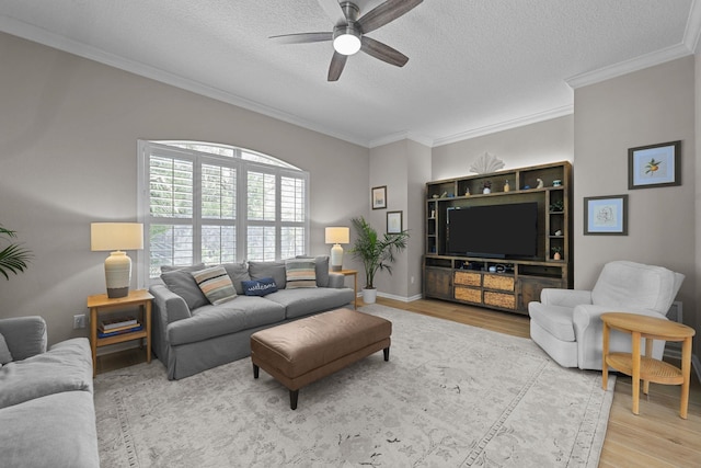 living room featuring a textured ceiling, ornamental molding, light hardwood / wood-style floors, and ceiling fan