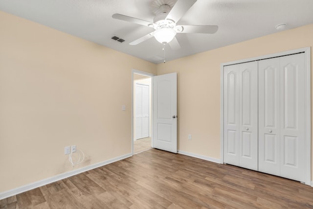 unfurnished bedroom with a closet, ceiling fan, and light hardwood / wood-style flooring