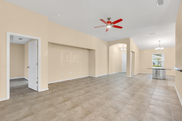 unfurnished living room with ceiling fan with notable chandelier and lofted ceiling