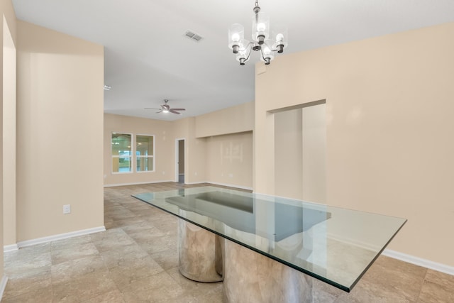 unfurnished dining area with ceiling fan with notable chandelier