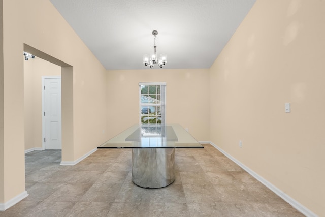 unfurnished dining area featuring an inviting chandelier