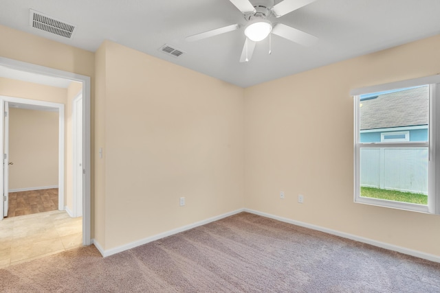 carpeted empty room featuring ceiling fan