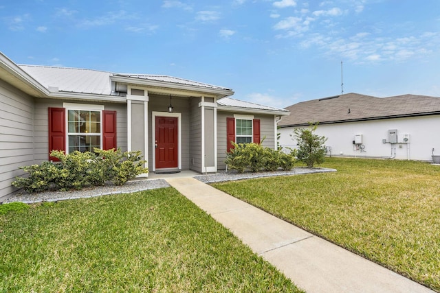 entrance to property with a lawn