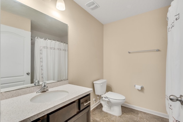 bathroom with toilet and vanity