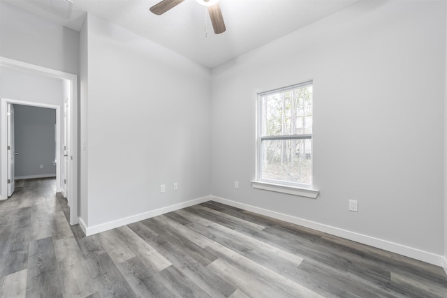 empty room with ceiling fan and hardwood / wood-style floors