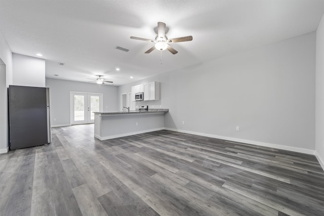 unfurnished living room featuring french doors, ceiling fan, and wood-type flooring