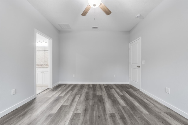 empty room featuring ceiling fan and hardwood / wood-style floors