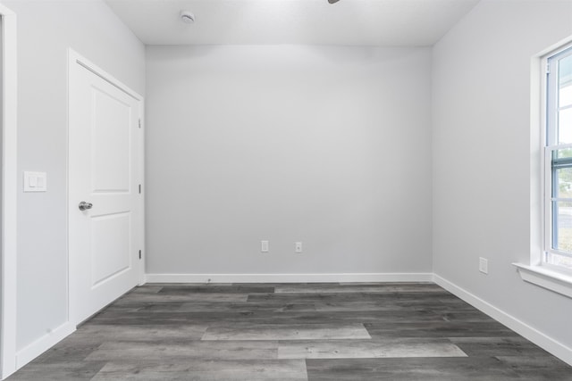 unfurnished room with dark hardwood / wood-style floors