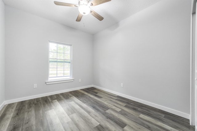 spare room with dark wood-type flooring and ceiling fan