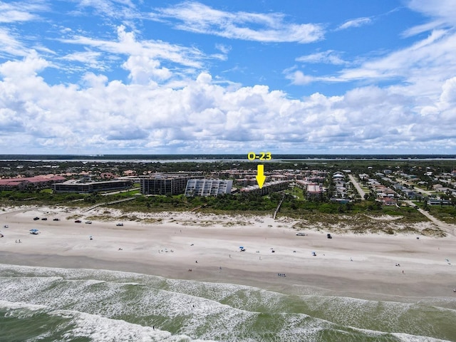 birds eye view of property with a water view and a view of the beach