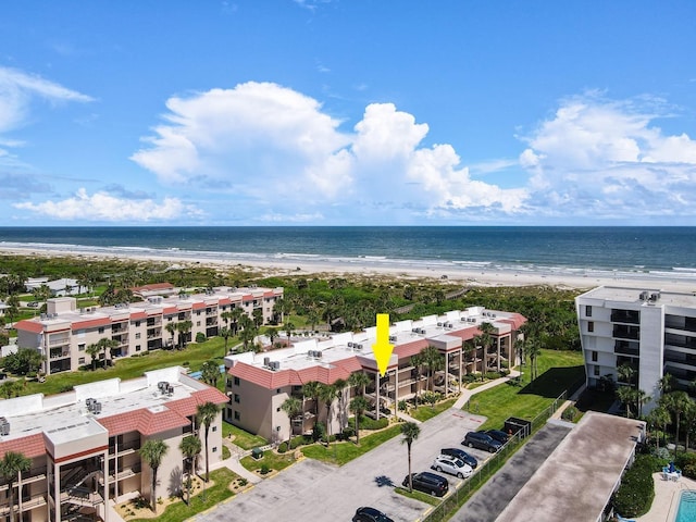 bird's eye view with a water view and a beach view