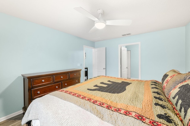 bedroom with hardwood / wood-style floors and ceiling fan