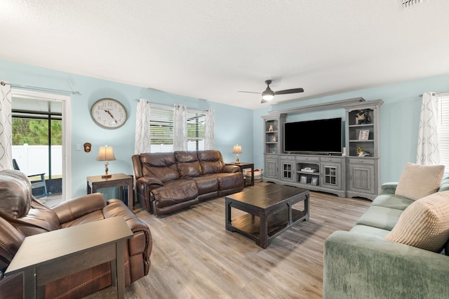 living room featuring light hardwood / wood-style floors and ceiling fan