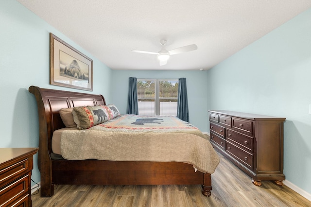 bedroom featuring light wood-type flooring and ceiling fan