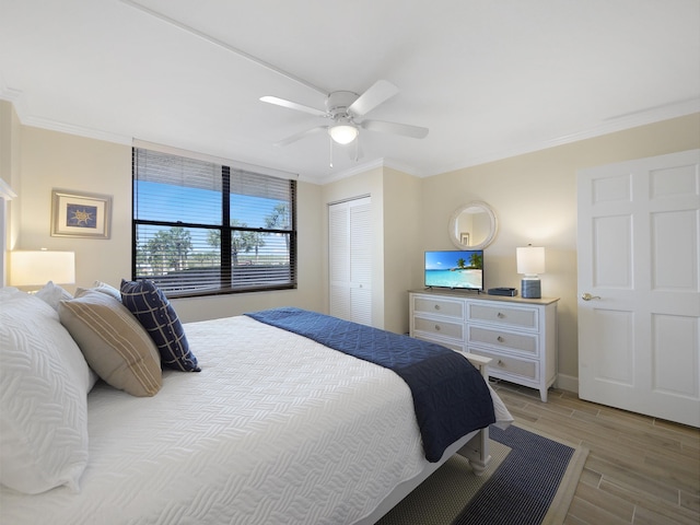 6240 A1A S Unit 103, Saint Augustine, FL 32080 - bedroom featuring ceiling fan, a closet, ornamental molding, wood tiled floor, and baseboards