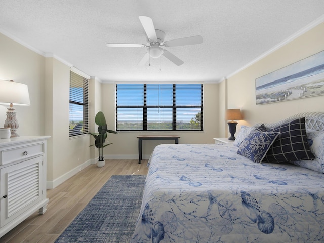 6240 A1A S Unit 103, Saint Augustine, FL 32080 - bedroom featuring baseboards, light wood-type flooring, ornamental molding, and a textured ceiling