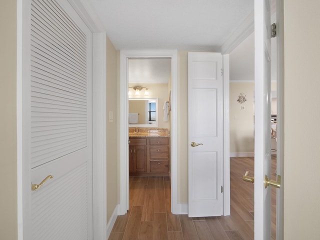 6240 A1A S Unit 103, Saint Augustine, FL 32080 - corridor featuring wood finished floors, a sink, and baseboards