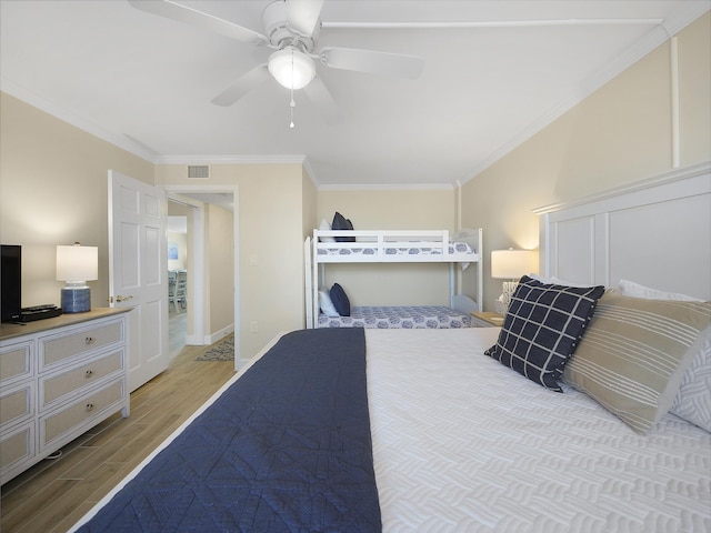 6240 A1A S Unit 103, Saint Augustine, FL 32080 - bedroom with crown molding, a ceiling fan, visible vents, wood finished floors, and baseboards