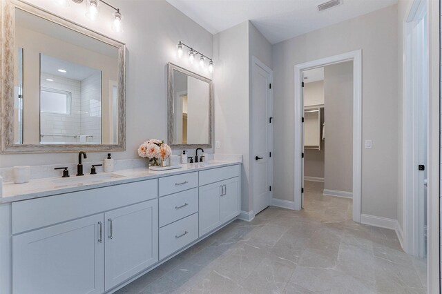 bathroom with vanity and a shower