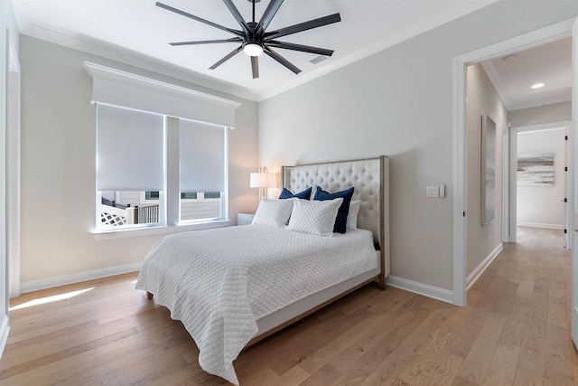 bedroom featuring ornamental molding, light hardwood / wood-style floors, and ceiling fan