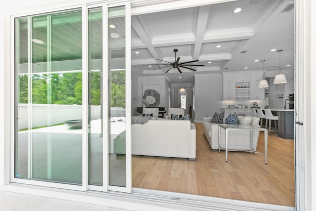 living room featuring sink, light hardwood / wood-style flooring, ceiling fan, beam ceiling, and coffered ceiling