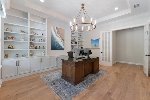 home office with french doors, light hardwood / wood-style flooring, a raised ceiling, built in features, and a notable chandelier