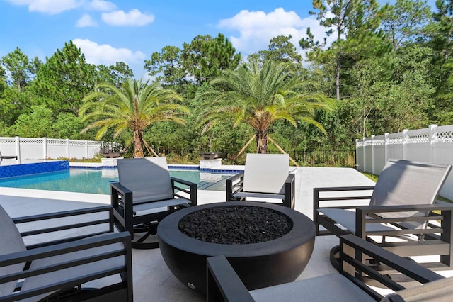 view of patio with a fenced in pool and an outdoor fire pit