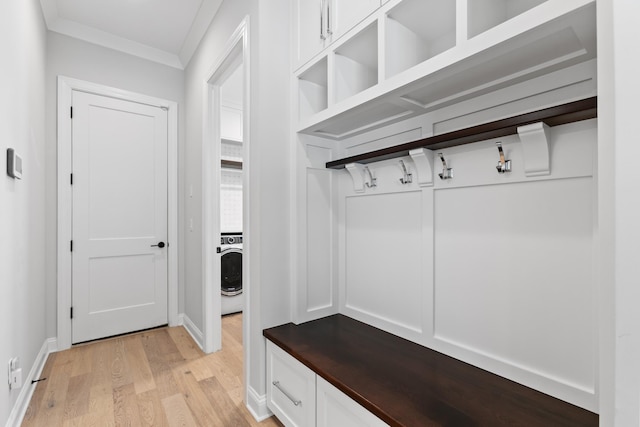 mudroom with crown molding, washer / dryer, and light wood-type flooring