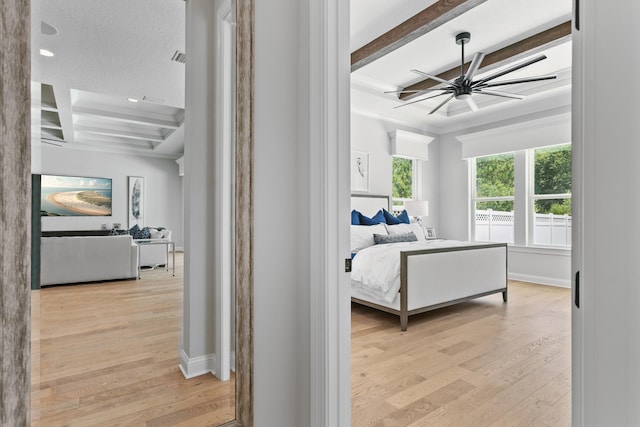 bedroom featuring coffered ceiling, a textured ceiling, light wood-type flooring, beamed ceiling, and ceiling fan