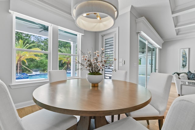 dining area featuring coffered ceiling, beam ceiling, ornamental molding, and ceiling fan