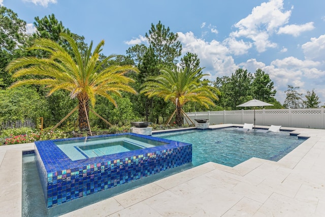 view of swimming pool featuring a patio and an in ground hot tub