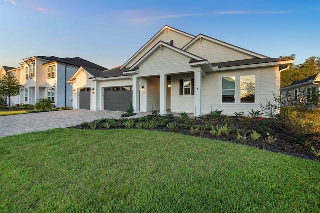 view of front of house with a garage and a front lawn