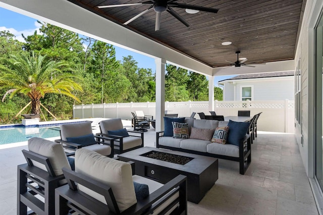 view of patio / terrace featuring a fenced in pool, an outdoor living space with a fire pit, and ceiling fan