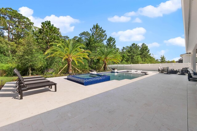 view of pool featuring an in ground hot tub and a patio