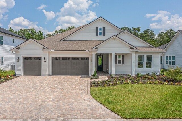 view of front of property featuring a garage and a front yard