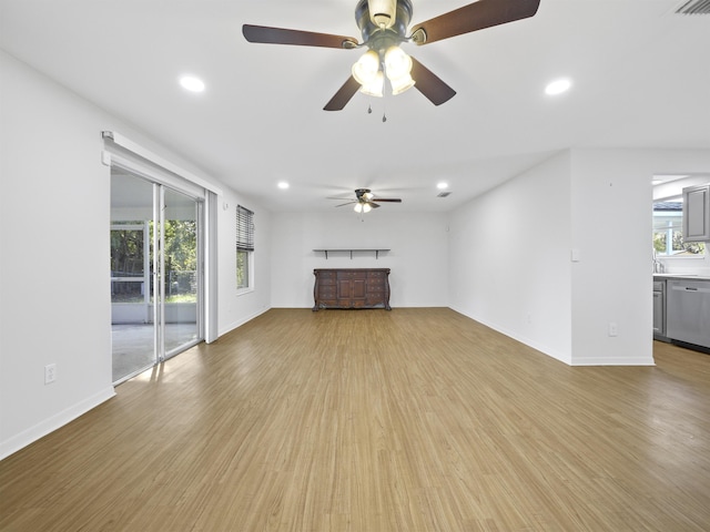 unfurnished living room featuring ceiling fan and light hardwood / wood-style flooring