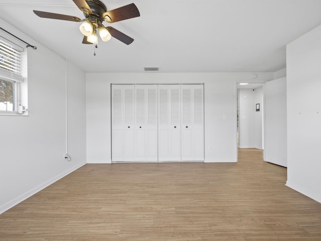 unfurnished bedroom with a closet, ceiling fan, and light hardwood / wood-style flooring