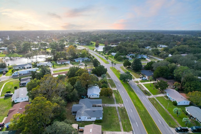 aerial view at dusk with a water view