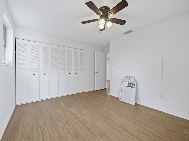 unfurnished bedroom with ceiling fan and light hardwood / wood-style floors