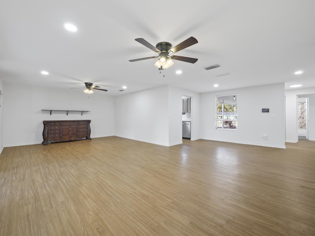 unfurnished living room featuring light hardwood / wood-style flooring and ceiling fan