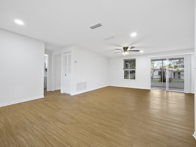 spare room with hardwood / wood-style flooring and ceiling fan