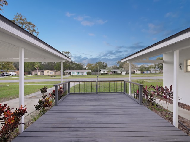 wooden deck with covered porch and a yard