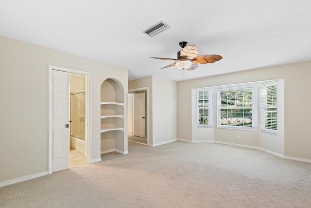 unfurnished room with light colored carpet, visible vents, and baseboards